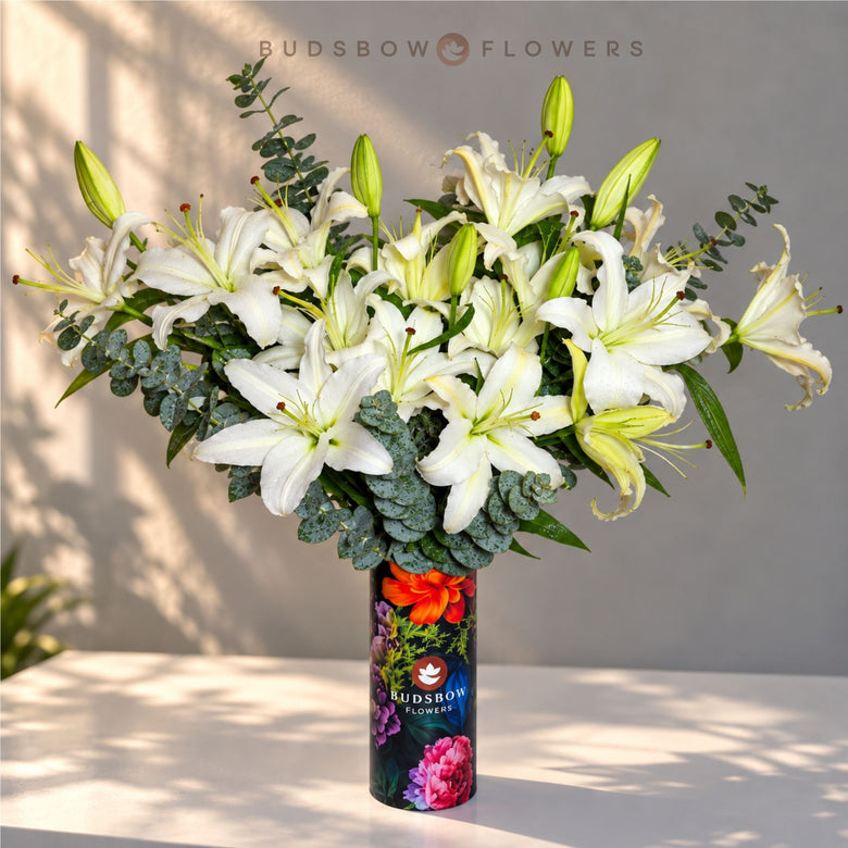 Ivory Lily Grandeur — white Oriental lilies with eucalyptus in a decorative vase